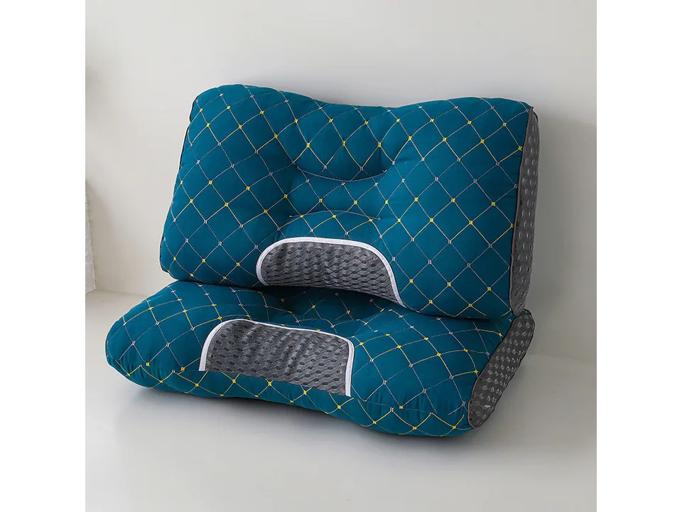 Blue ergonomic neck support pillow with quilted pattern.