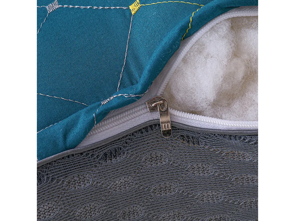 Close-up of the pillow zipper and soft white filling material.