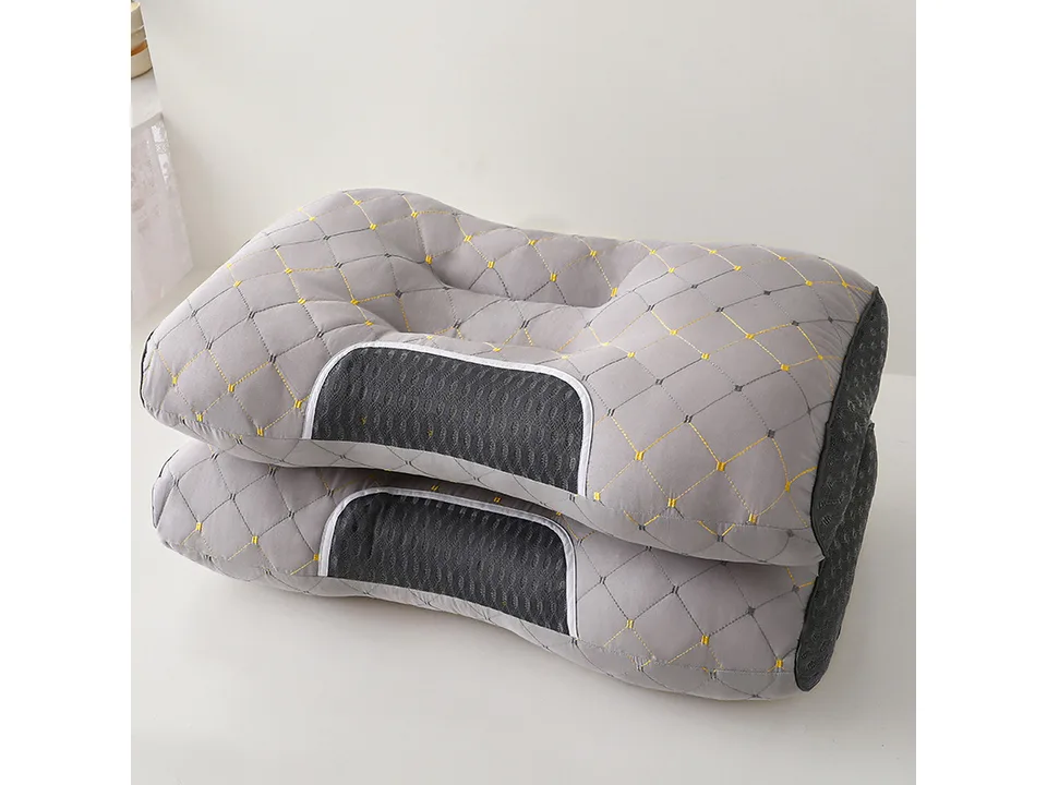 Grey ergonomic neck support pillow with quilted pattern.
