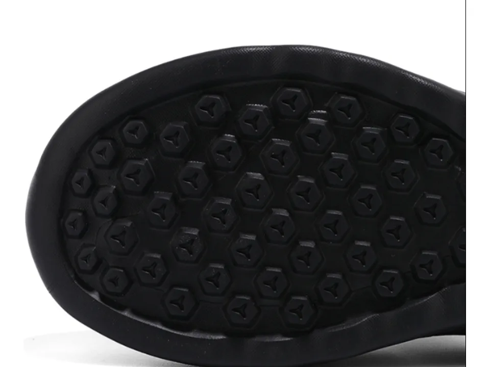 Close-up view of the textured, non-slip rubber sole of the slipper.