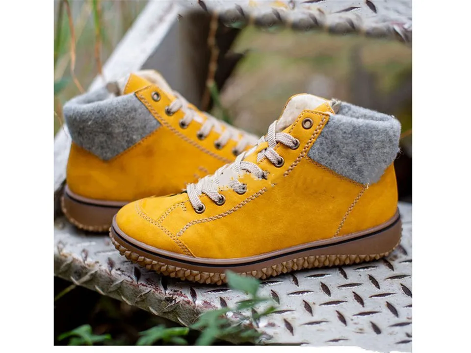 Yellow lace-up snow boots with a grey wool cuff and thick brown sole.