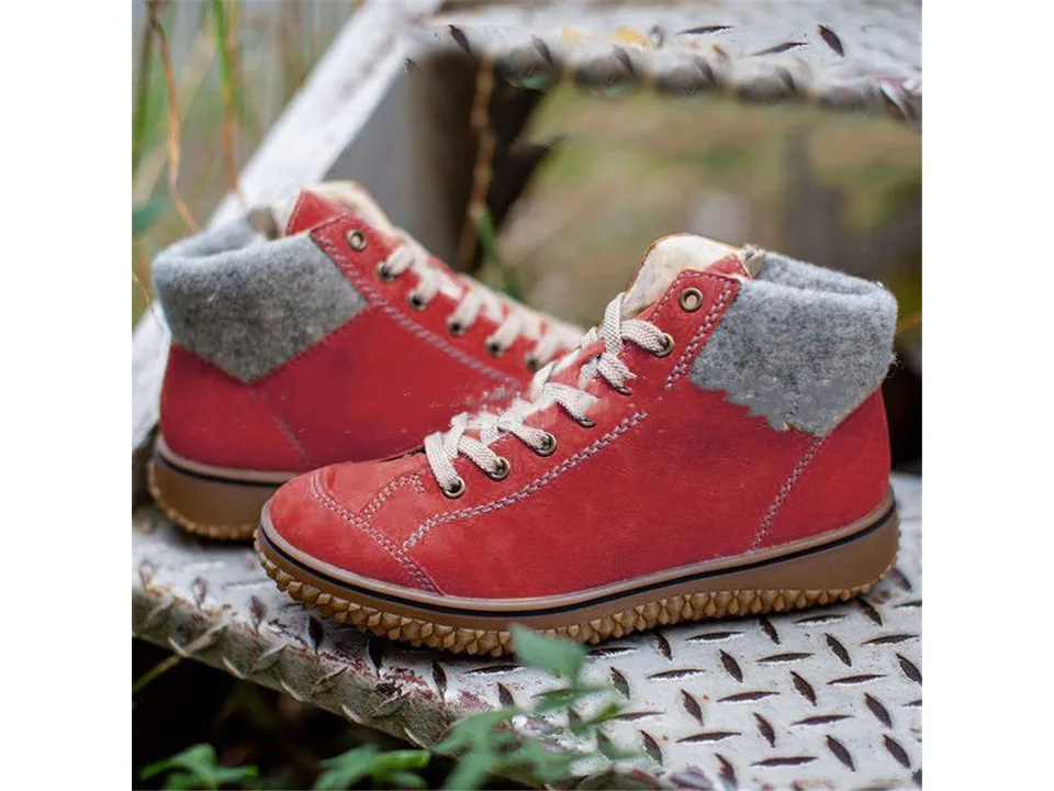 Red lace-up snow boots with a grey wool cuff and thick brown sole.
