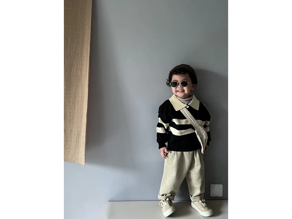 A child wearing the striped knit pullover sweater with a lapel collar.