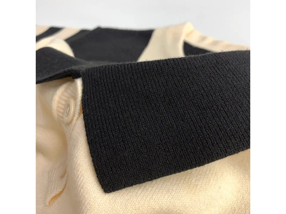 Close-up of the black and cream knit collar and fabric texture.