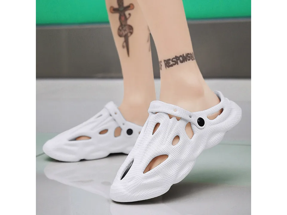 A person wearing white EVA foam clogs.