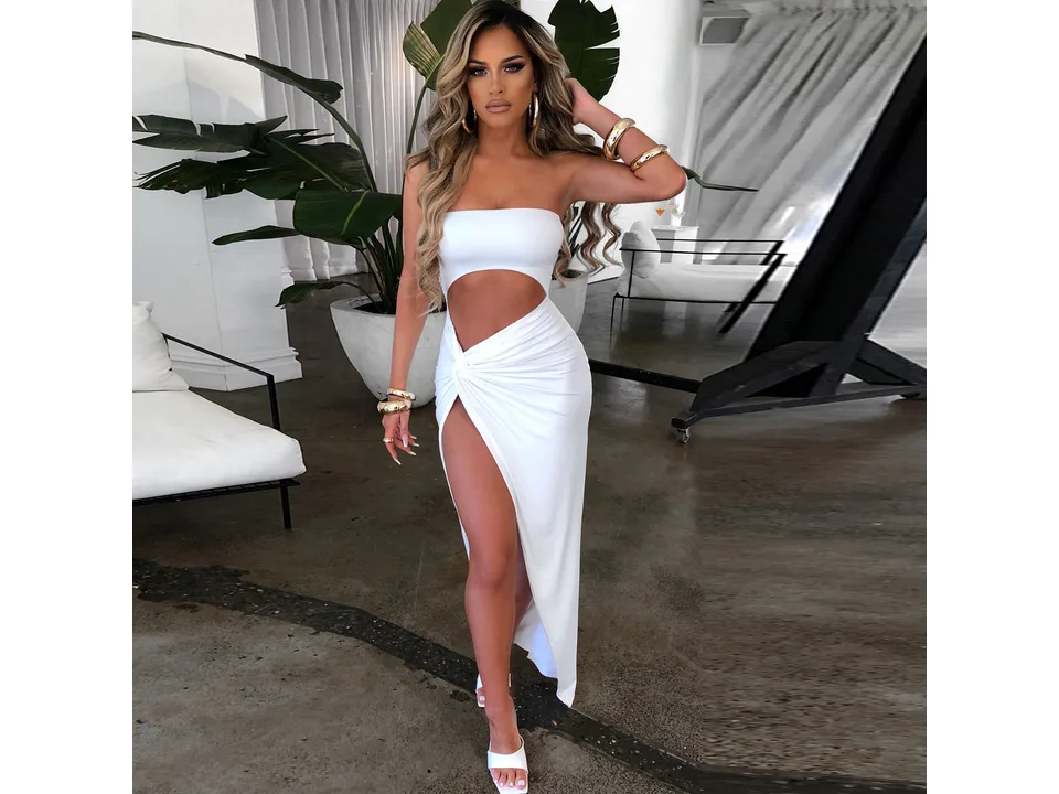 Model wearing a white strapless cut-out maxi dress with a high slit.
