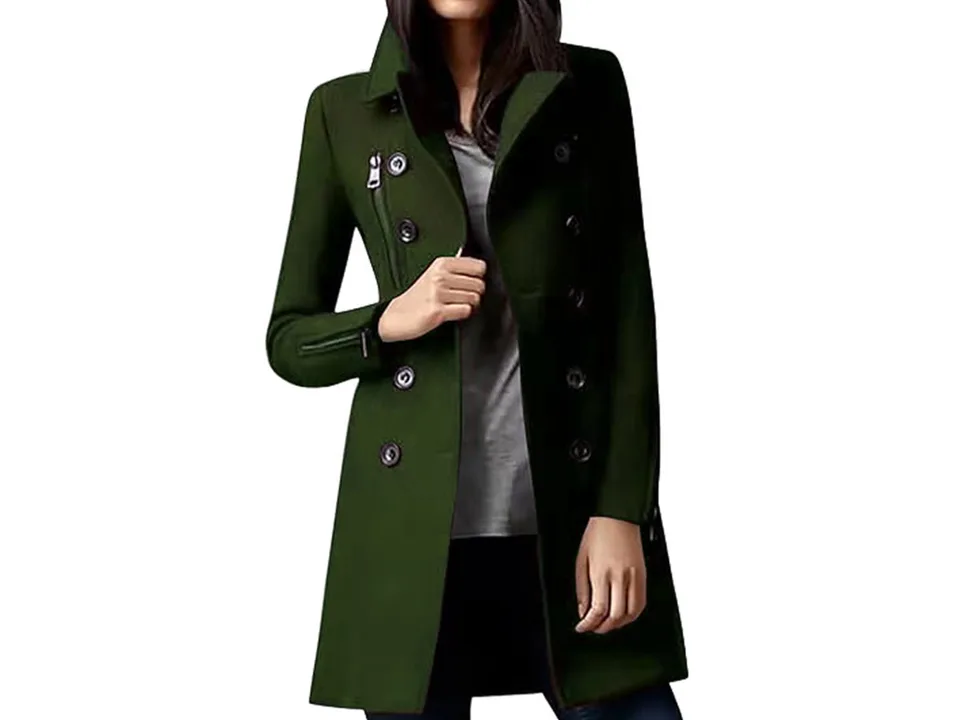 A woman wearing a green double-breasted coat.