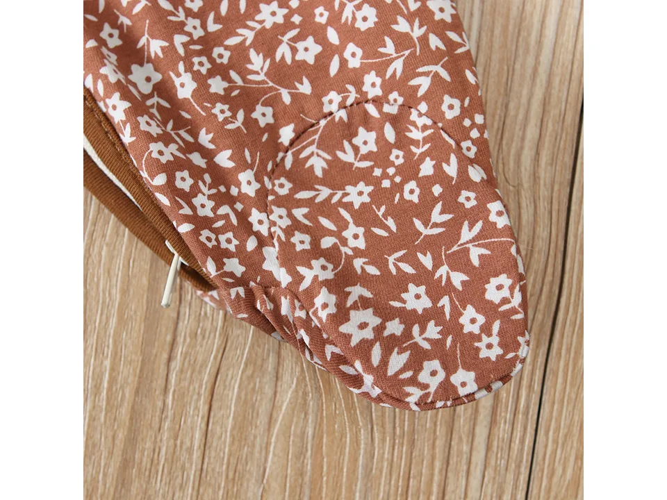 Close-up of the footed section of the floral baby jumpsuit.