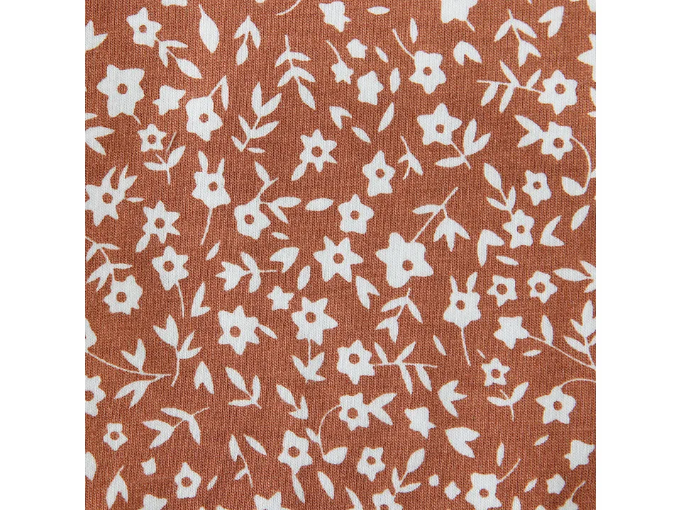 Close-up view of the brown and white floral fabric pattern.