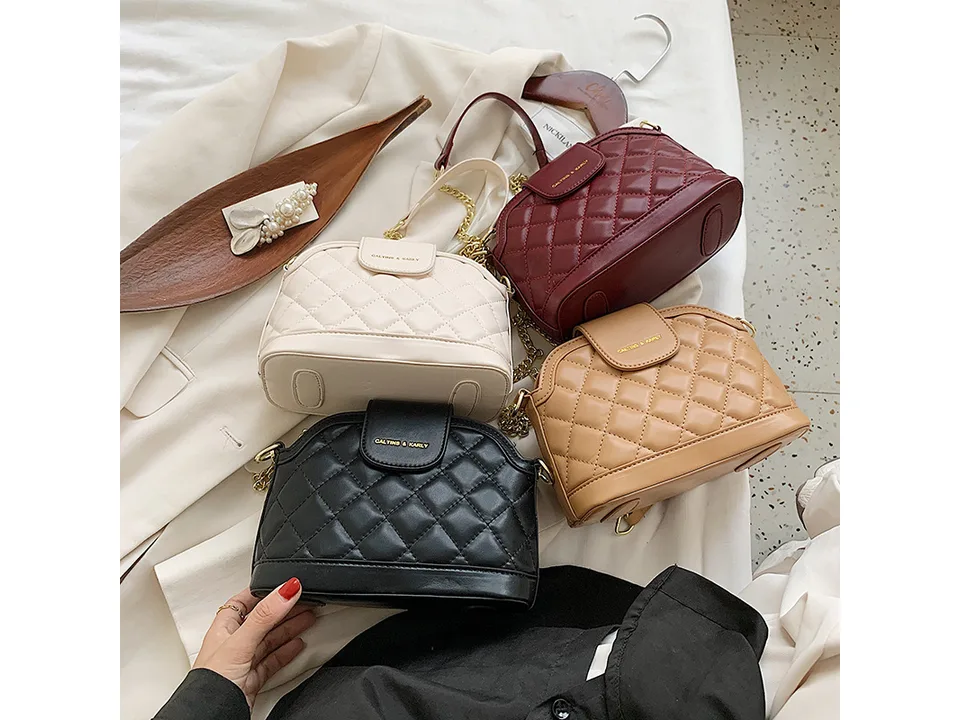Four quilted shoulder bags in different colors stacked together