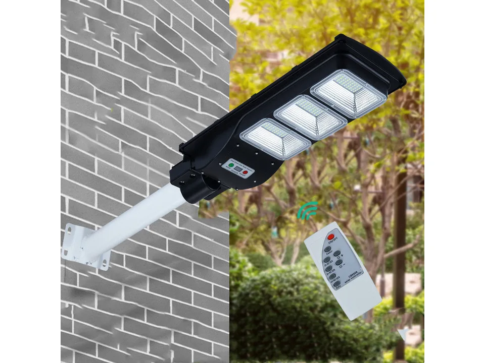 Solar street light mounted on a brick wall with a remote control shown nearby.