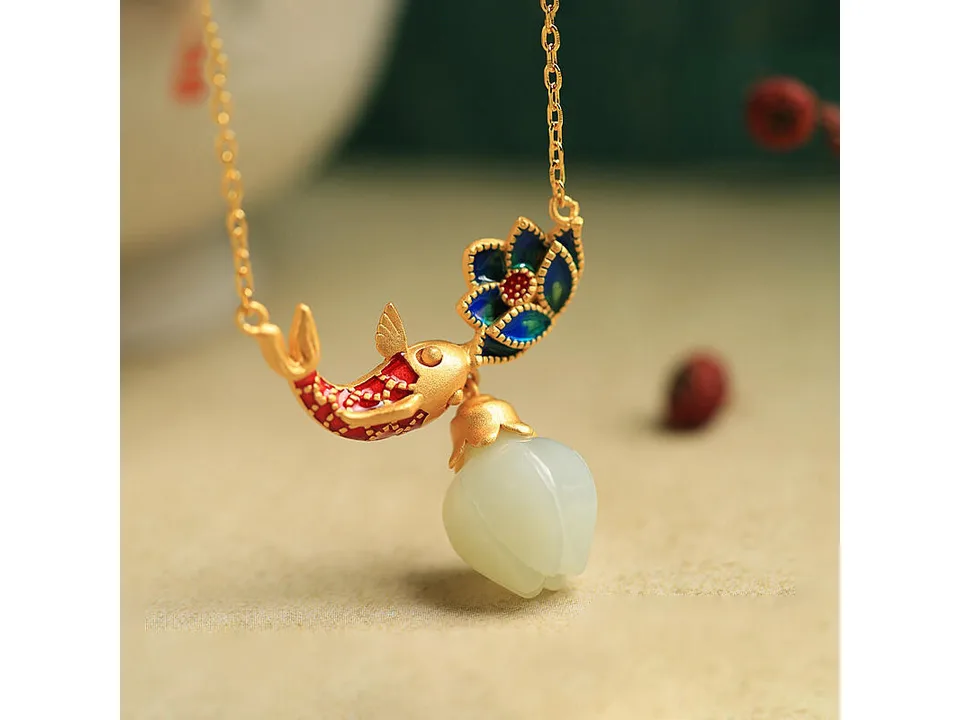 Close-up of the koi and lotus pendant with a white jade drop.