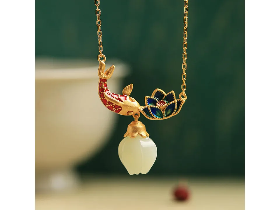Koi fish and lotus pendant necklace with a white jade charm.