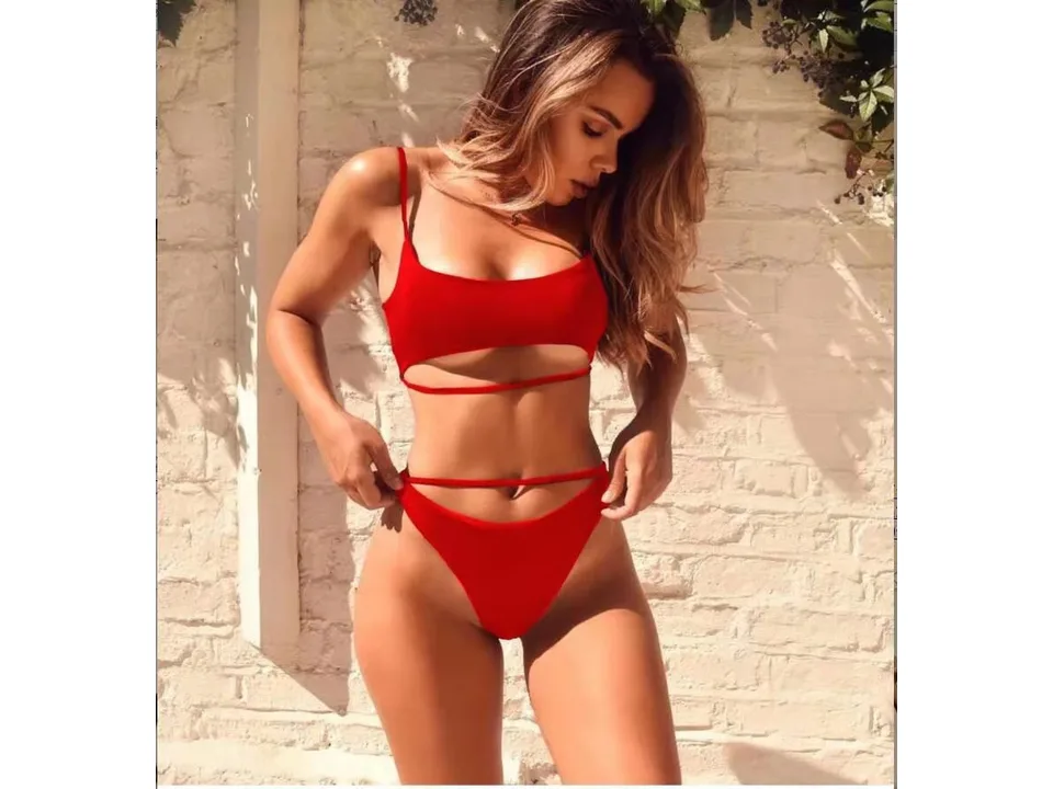 A woman wearing a red two-piece bikini with cutout details.