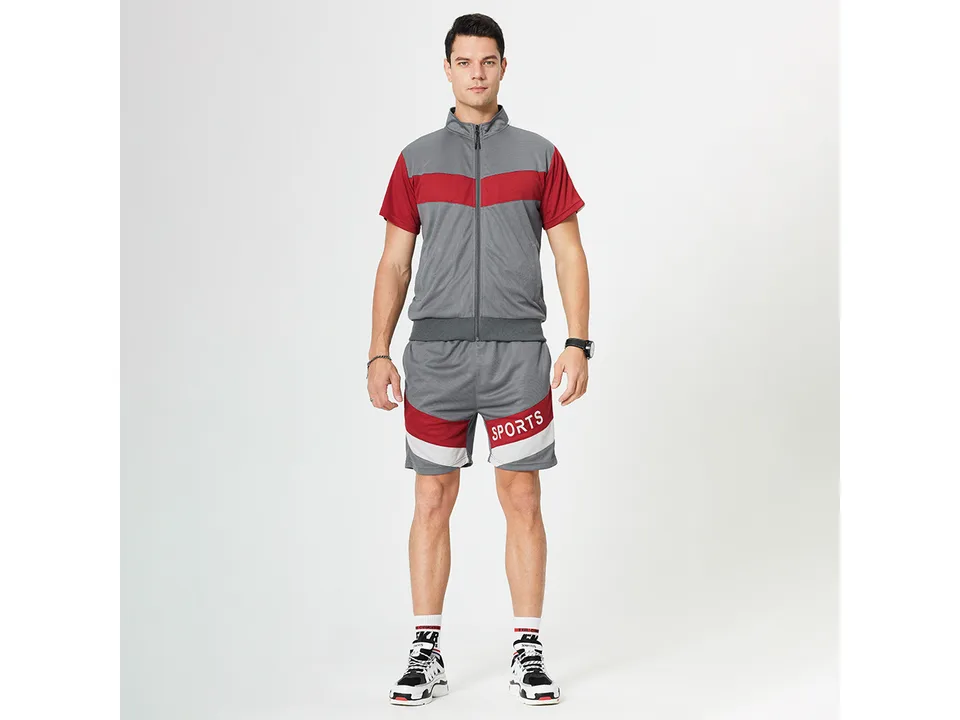 Front view of a man wearing the grey and red sports suit.