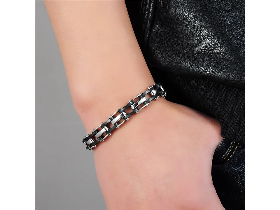 The bracelet worn on a man's wrist.
