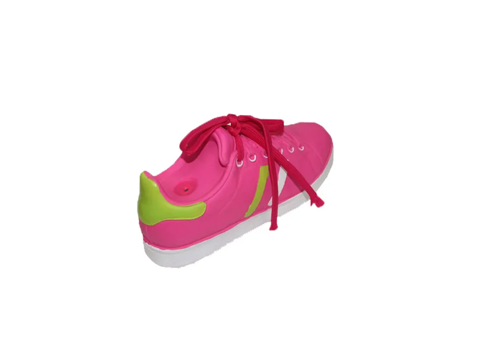 A pink shoe-shaped dog toy with green accents.