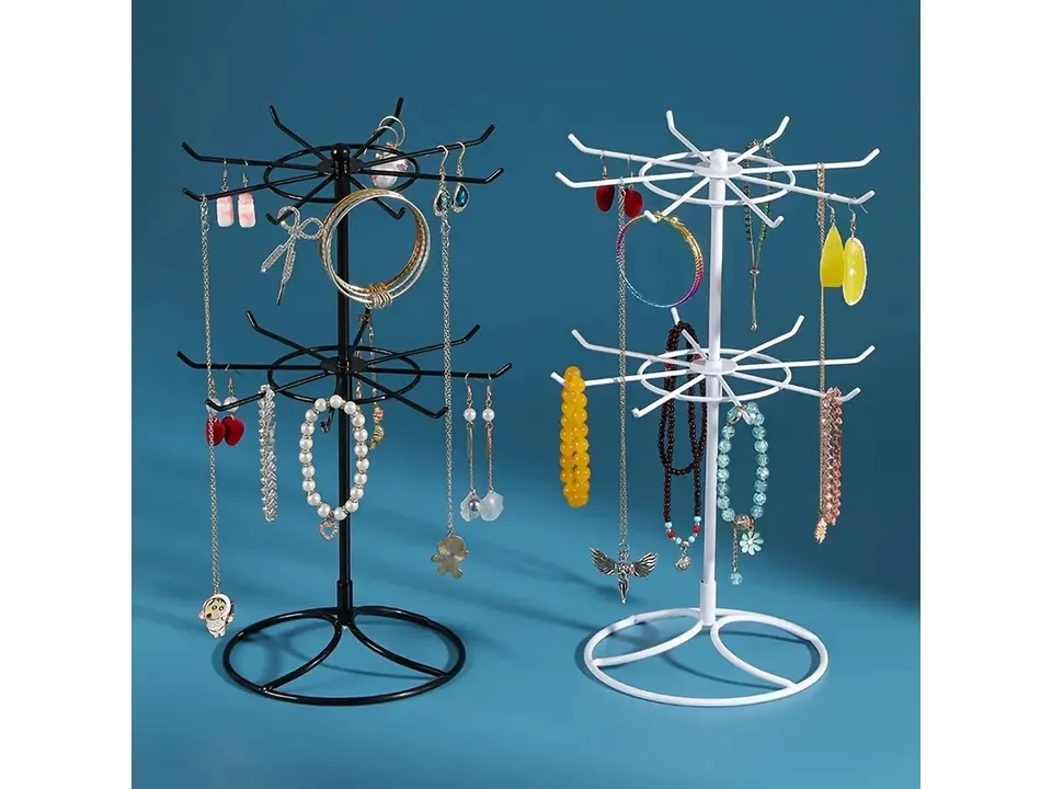 Black and white two-tier jewelry display stands side-by-side, both fully stocked with jewelry.