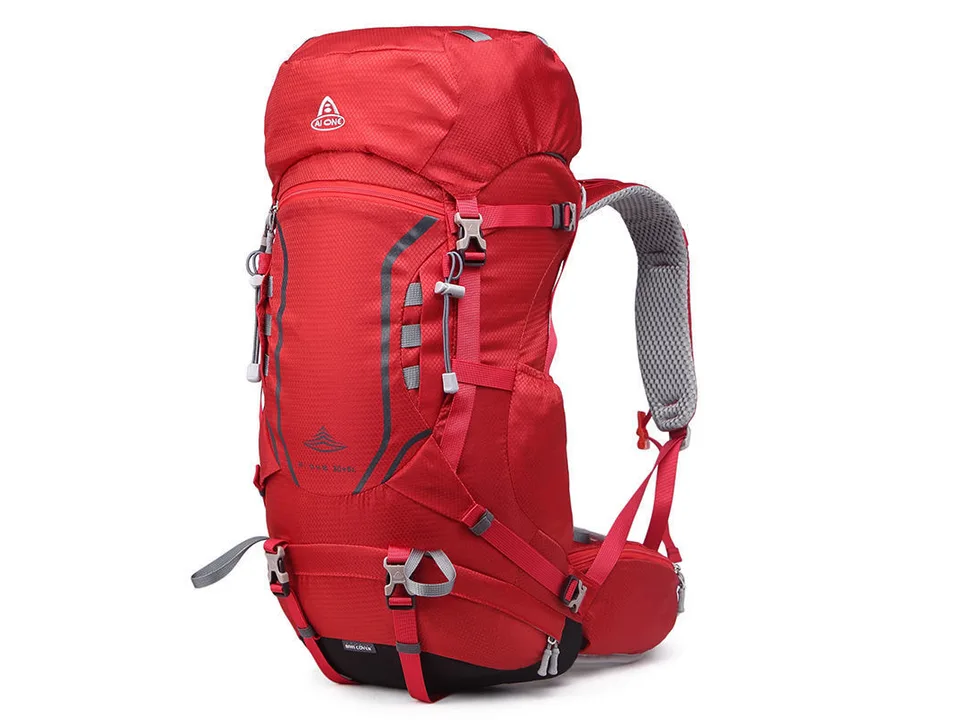 Red hiking backpack, side view, showing straps and padding.