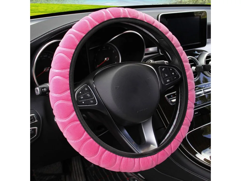 Pink plush steering wheel cover installed on a car steering wheel.