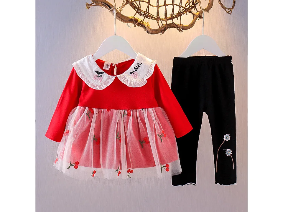 Red long-sleeved dress with cherry print and tulle skirt, paired with black leggings.