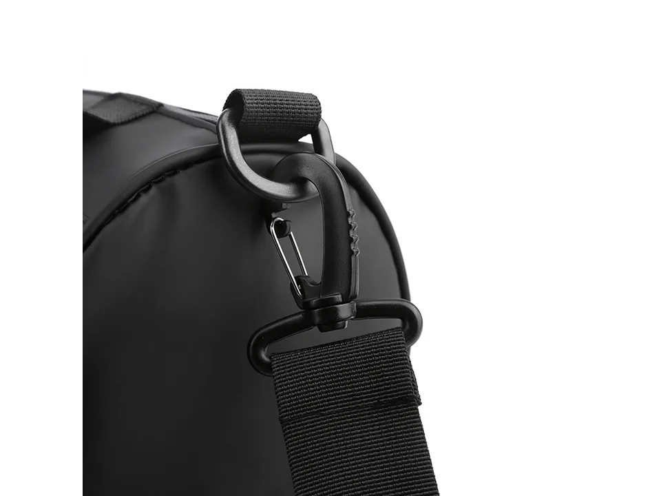 Close-up of the black plastic carabiner clip and strap attachment on the bag.
