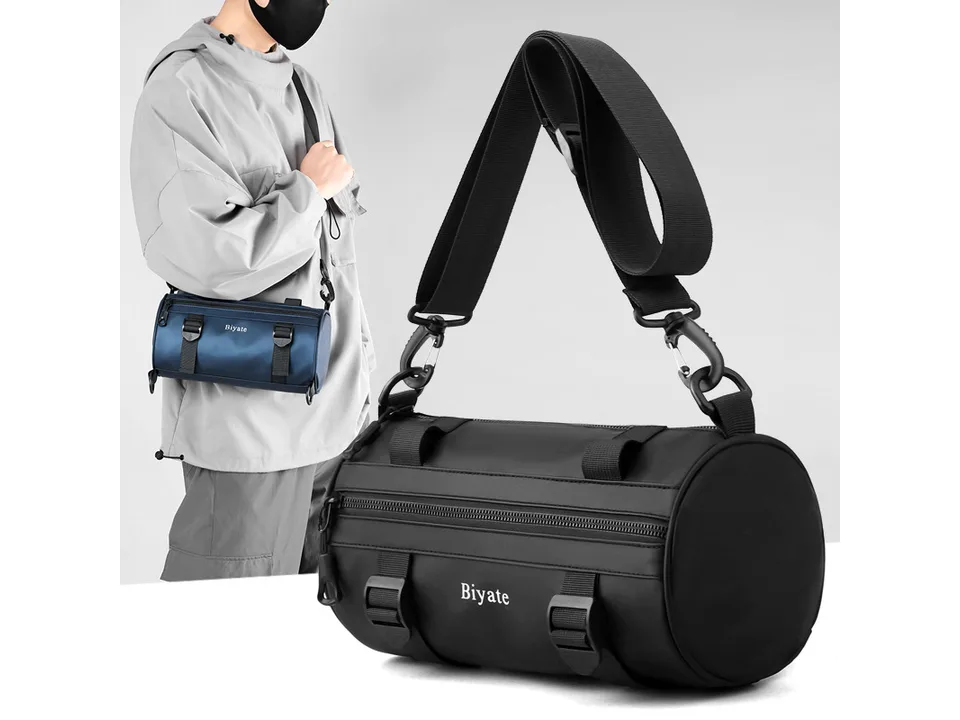 Person wearing a blue version of the cylindrical crossbody bag.