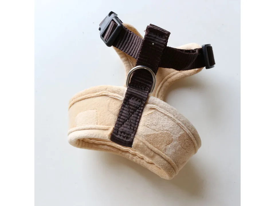 Back view of the beige plush dog harness showing the metal D-ring.