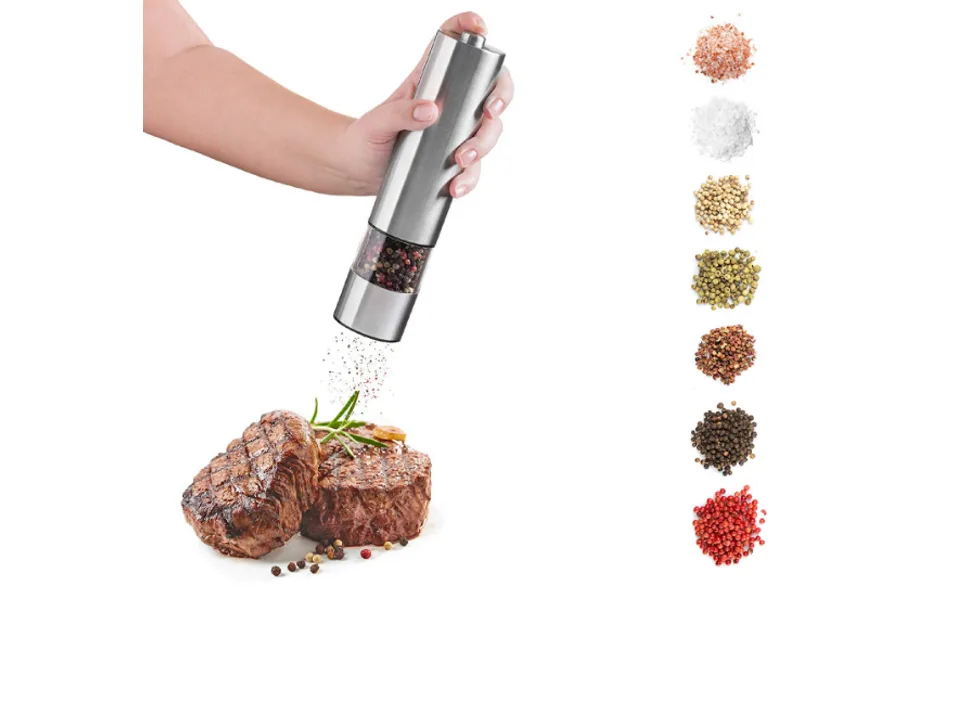 A hand using an electric salt and pepper grinder over a steak.