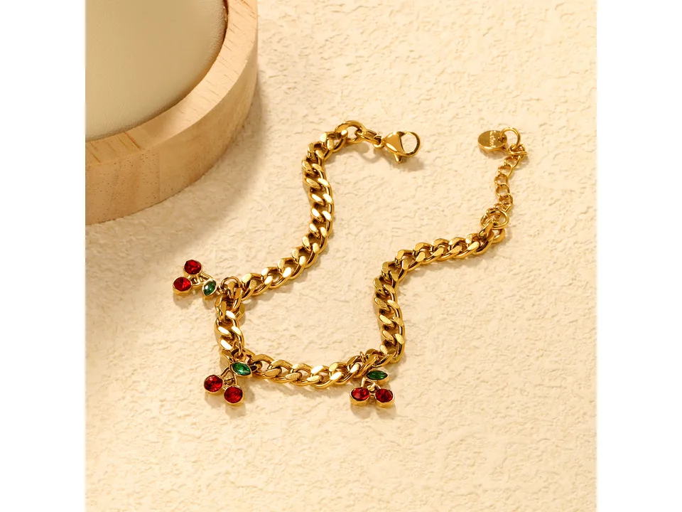 Gold-plated chain bracelet with three cherry charms featuring red and green crystals.