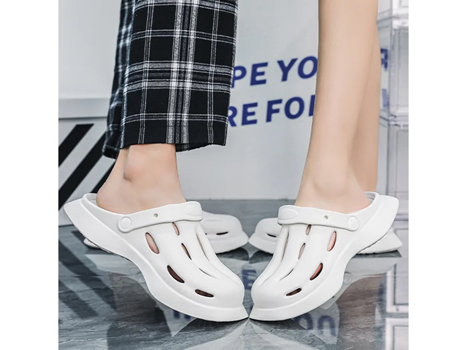 Side view of a person wearing white casual EVA clogs.