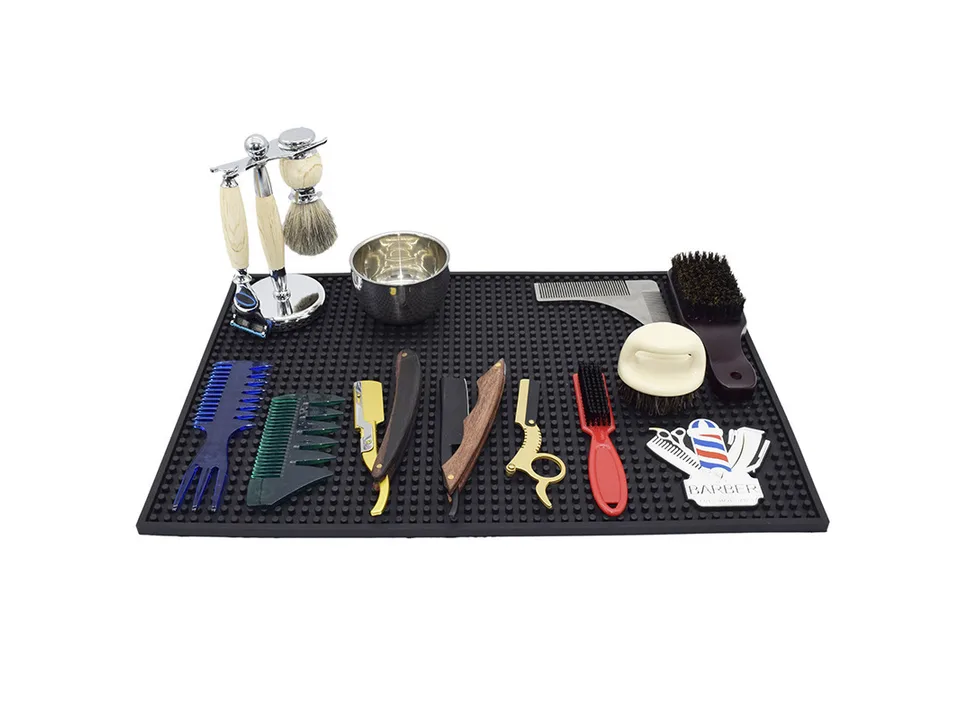 Barber station mat with various hairdressing tools arranged on top.