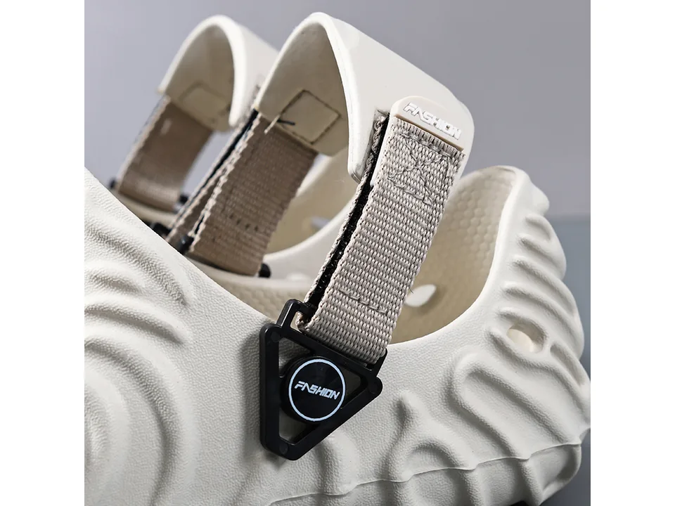 Close-up of the adjustable strap and buckle detail on the beige sandal.