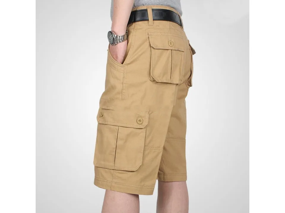 Side view of a man wearing khaki cargo shorts with multiple pockets.