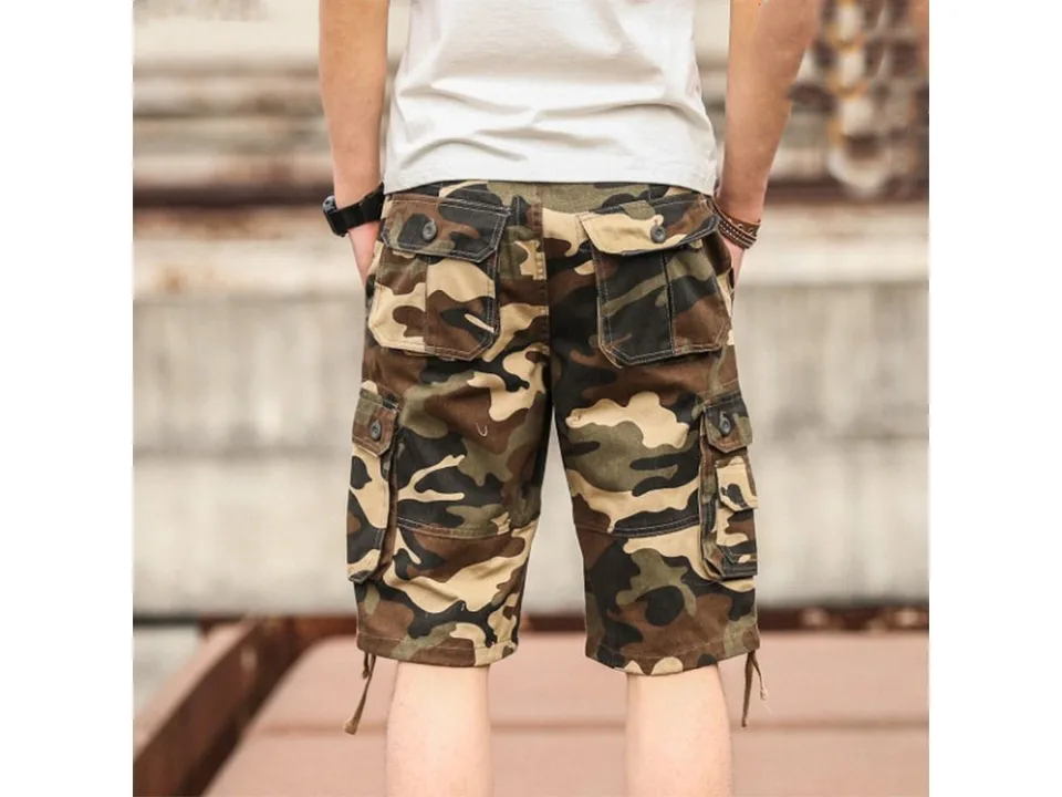 Back view of a man wearing camouflage cargo shorts with multiple pockets.
