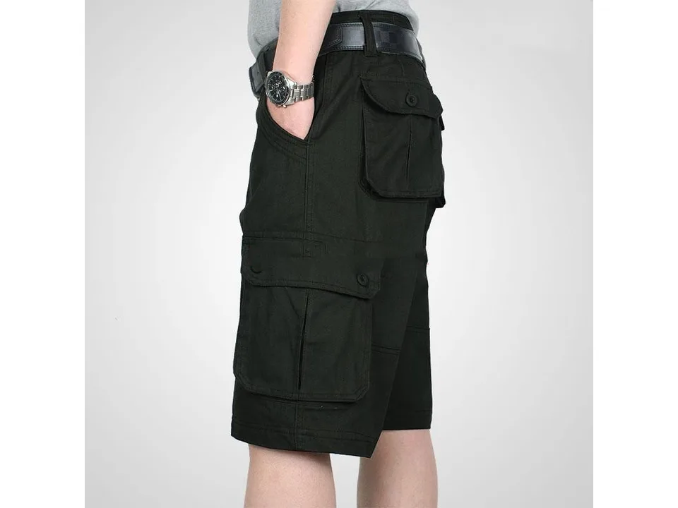 Side view of a man wearing black cargo shorts with multiple pockets.