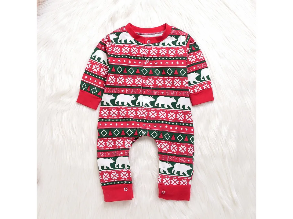 Front view of the Christmas-themed baby romper laid on a white faux fur rug.