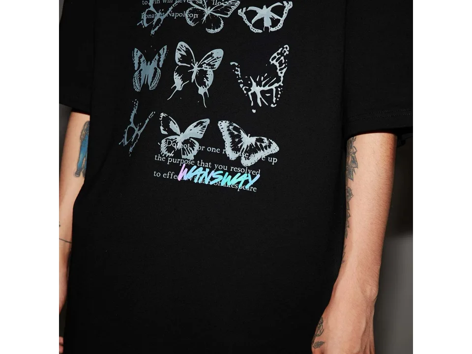 Close-up view of the butterfly graphic print on a black t-shirt.