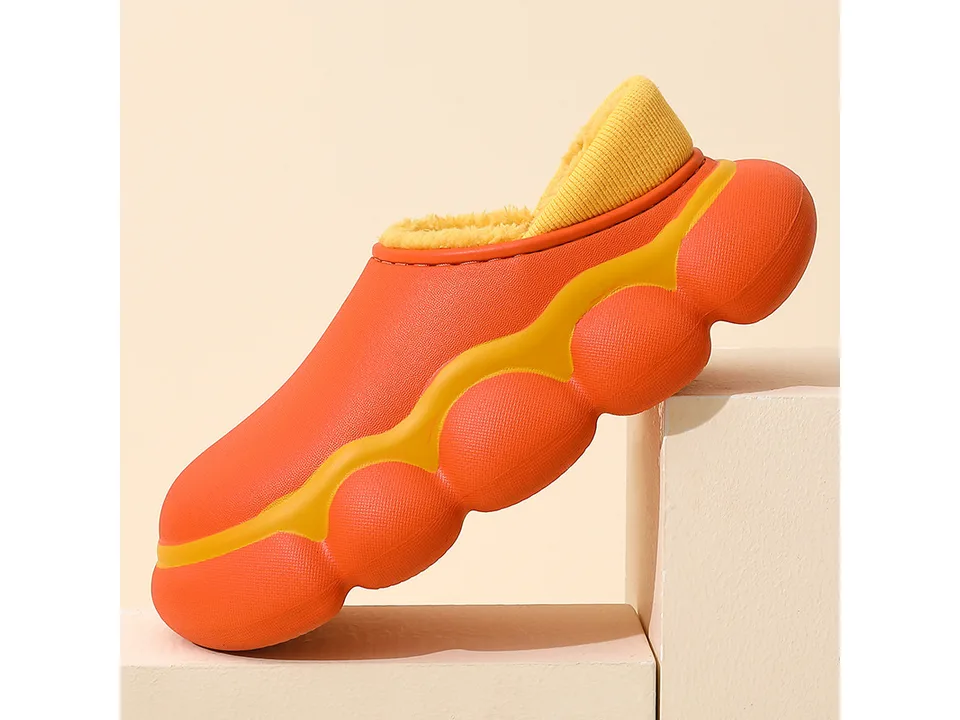 An orange EVA clog slipper with a yellow plush lining, shown from the side.