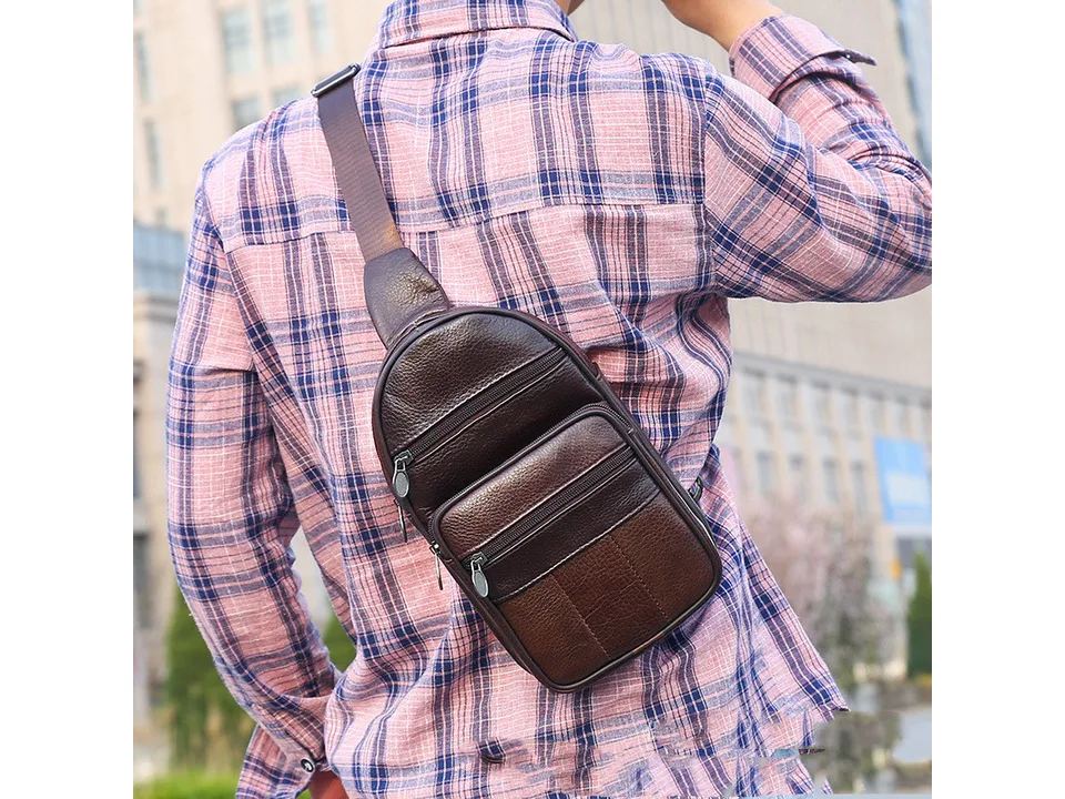 A man wearing the brown leather sling bag on his back.
