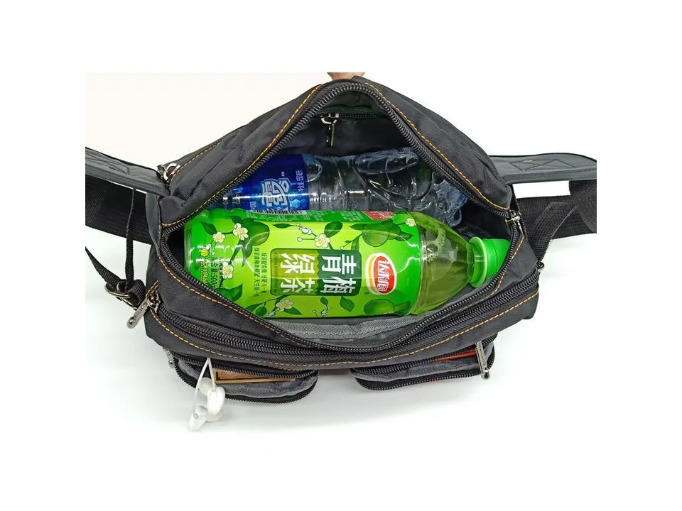 Black chest bag being used to carry a large plastic bottle of green tea.