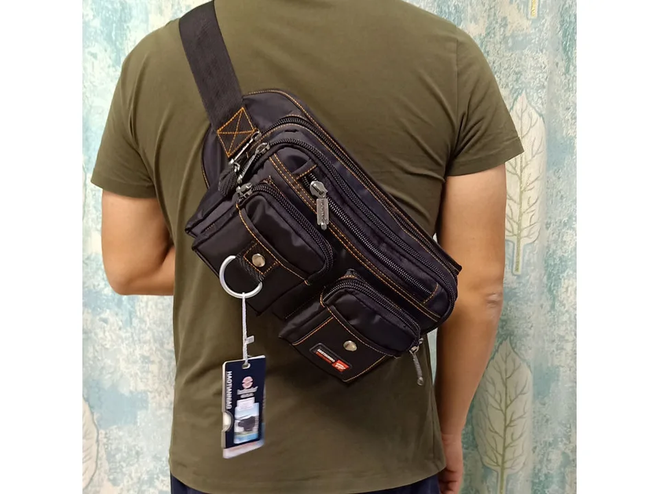 Person wearing the black chest bag across their back.