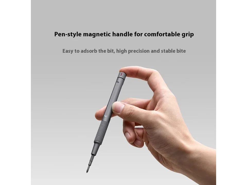 Hand holding a pen-style magnetic screwdriver handle.
