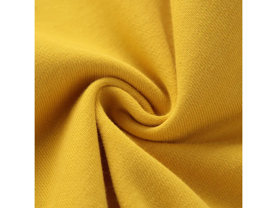 Close-up view of the yellow fabric texture of the baby romper.