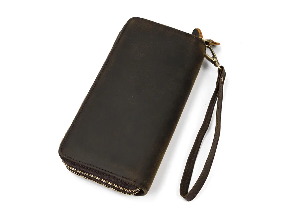 Dark brown leather clutch bag with a wrist strap attached.