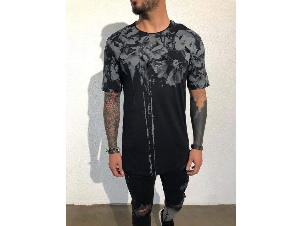 Front view of a man wearing a black floral print t-shirt.