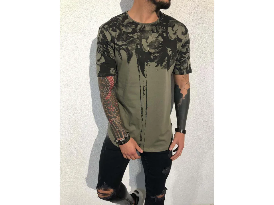 Front view of a man wearing an olive green floral print t-shirt.