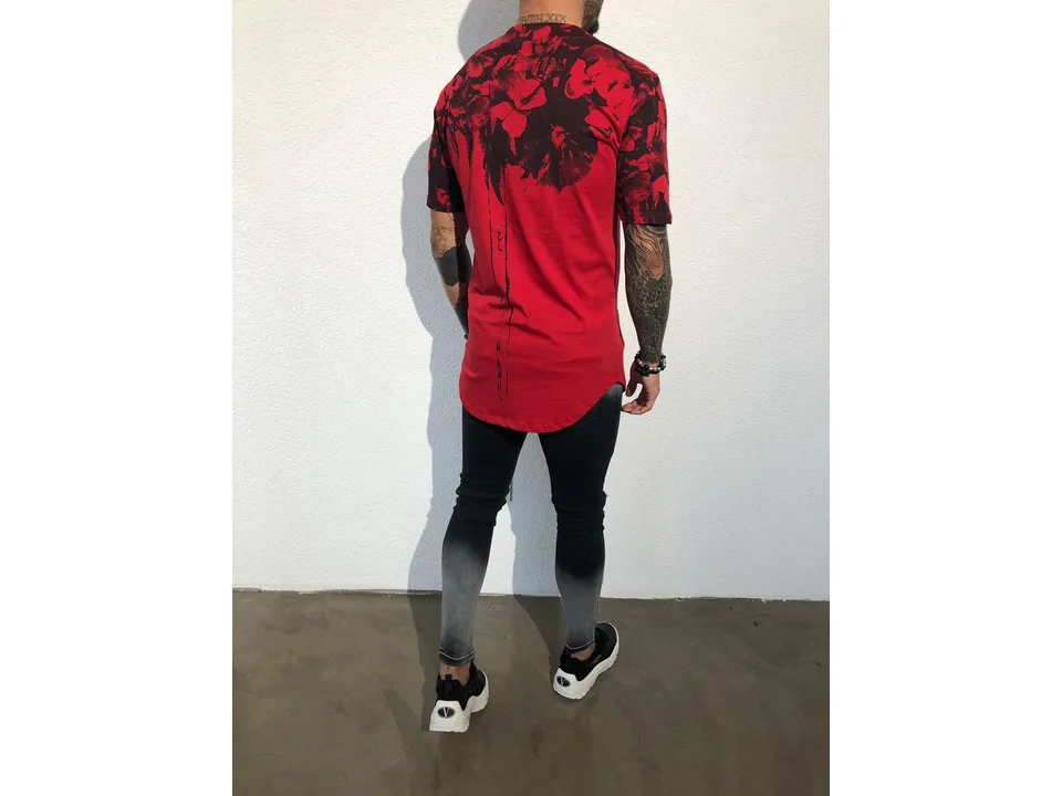 Back view of a man wearing a red floral print t-shirt.
