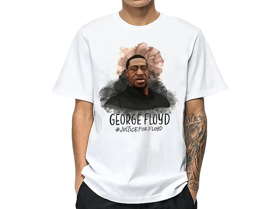 A man wearing a white t-shirt with a George Floyd graphic print