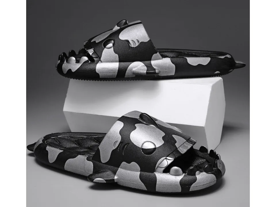 A pair of black and silver shark-themed slides.